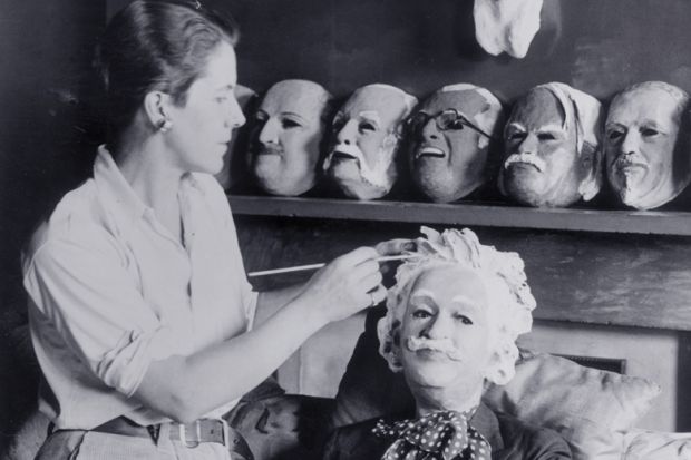 Woman making plaster puppet