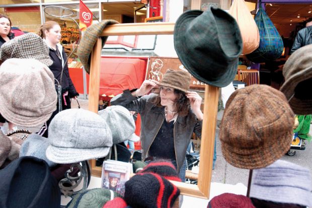 Woman tries on hats