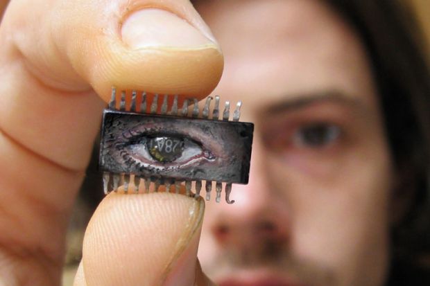 Yuri Zupancic holding microchip painting