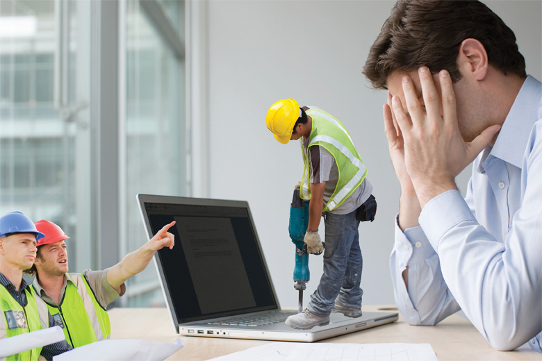 Tiny workmen working on stressed man's laptop