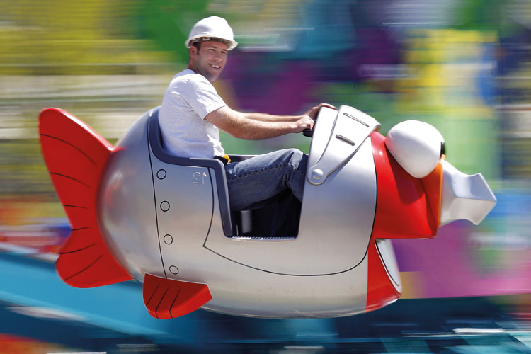 Workman riding in fish fairground ride