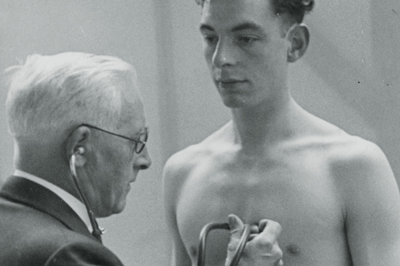 Young man having heart rate checked by doctor