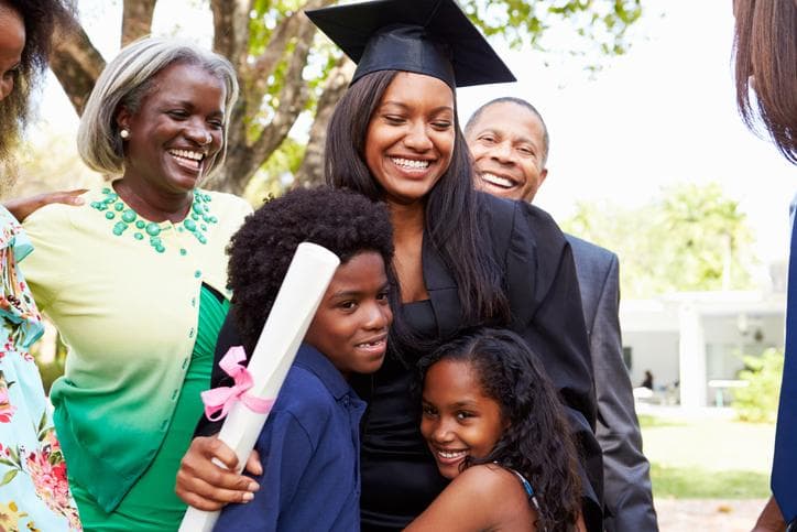 mature student at graduation with her children