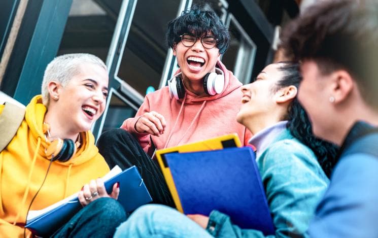 Students having fun together sitting outside 